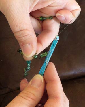 Carrie Lambert of Loveland, Colorado, crochets wire strung with beads.