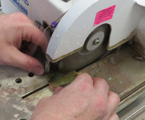 Ryan Gardner uses a trip saw to cut out a small area of agate