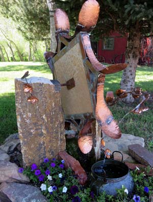 Waterwheel of copper and stone by Larry Pryor
